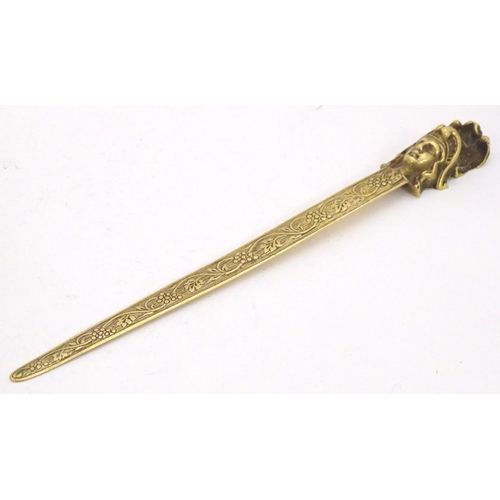 1278 - An early 20thC brass letter opener with classical head finial and grape and vine detail to blade. Ap... 