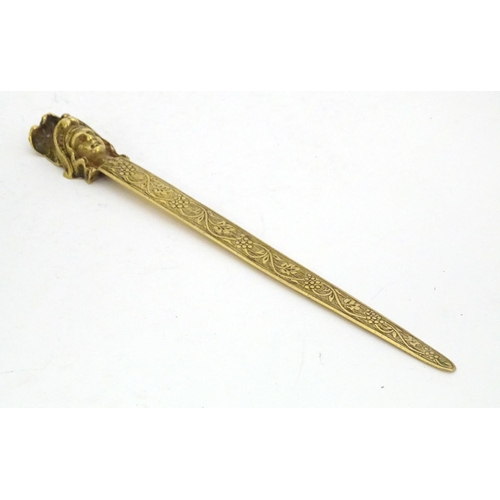 1278 - An early 20thC brass letter opener with classical head finial and grape and vine detail to blade. Ap... 