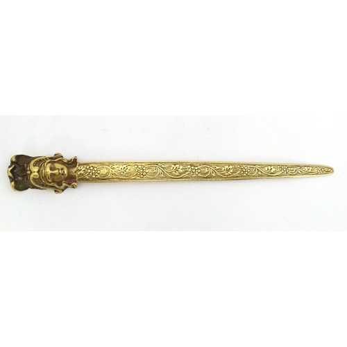 1278 - An early 20thC brass letter opener with classical head finial and grape and vine detail to blade. Ap... 