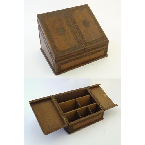 1336 - An early 20thC stationary / correspondence cabinet with two folding doors and fitted interior. The f... 