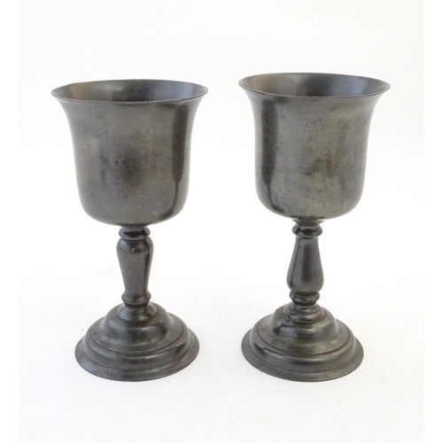 1360 - A matched pair of 19thC pewter pedestal cups / goblets. Largest approx. 9 1/4