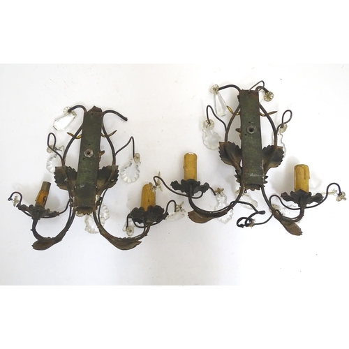 1364 - A pair of early 20thC Continental wall lights, decorated with gilt goat heads and patinated foliate ... 