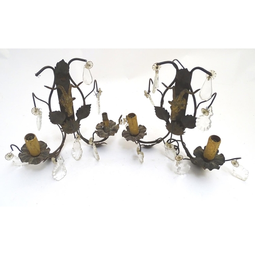 1364 - A pair of early 20thC Continental wall lights, decorated with gilt goat heads and patinated foliate ... 