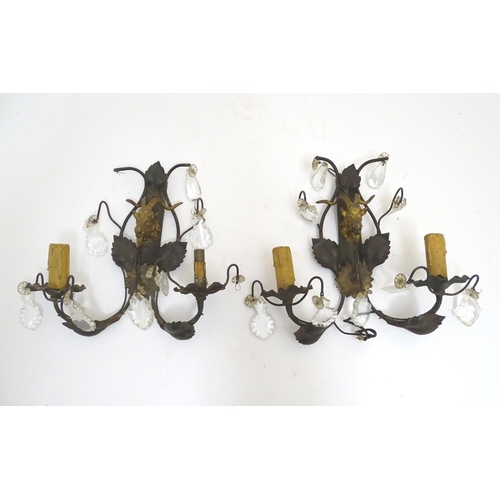 1364 - A pair of early 20thC Continental wall lights, decorated with gilt goat heads and patinated foliate ... 