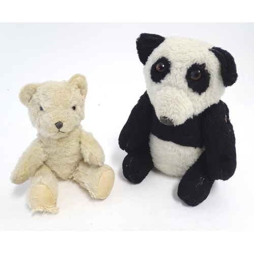 1486 - Toys: Two 20thC bears, comprising a panda bear with button jointed limbs, and a straw filled teddy b... 