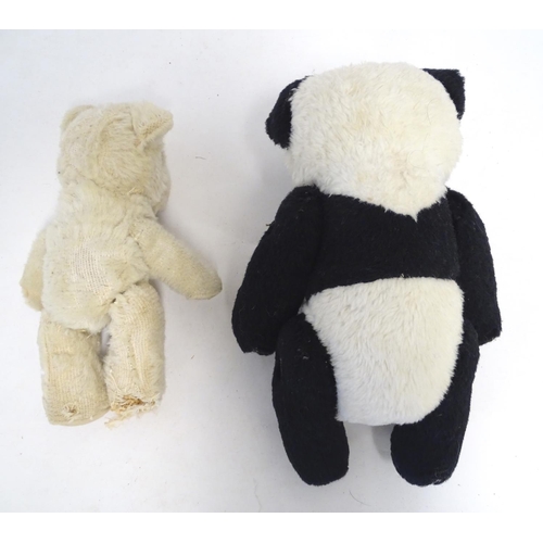 1486 - Toys: Two 20thC bears, comprising a panda bear with button jointed limbs, and a straw filled teddy b... 