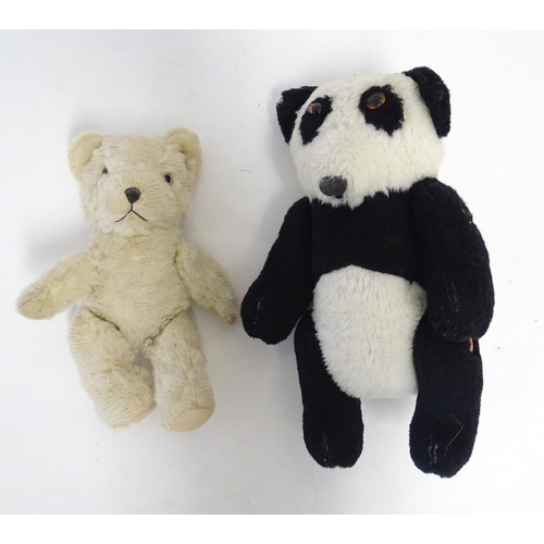 1486 - Toys: Two 20thC bears, comprising a panda bear with button jointed limbs, and a straw filled teddy b... 