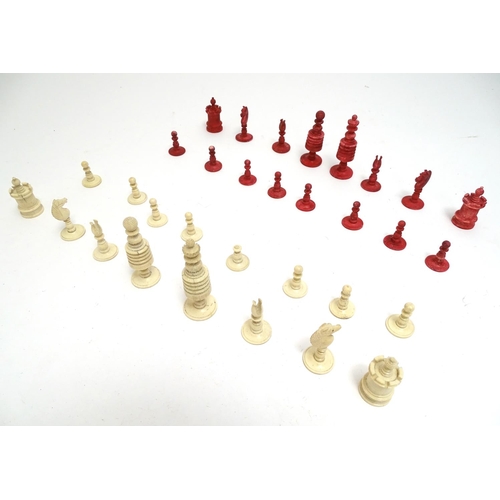 1487 - Toys: A 19thC / early 20thC set of turned and carved bone chess pieces, the largest approx. 4