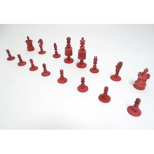 1487 - Toys: A 19thC / early 20thC set of turned and carved bone chess pieces, the largest approx. 4