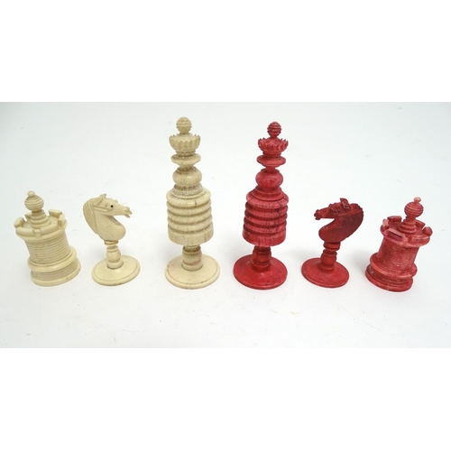 1487 - Toys: A 19thC / early 20thC set of turned and carved bone chess pieces, the largest approx. 4