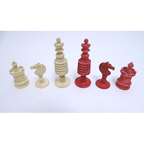 1487 - Toys: A 19thC / early 20thC set of turned and carved bone chess pieces, the largest approx. 4