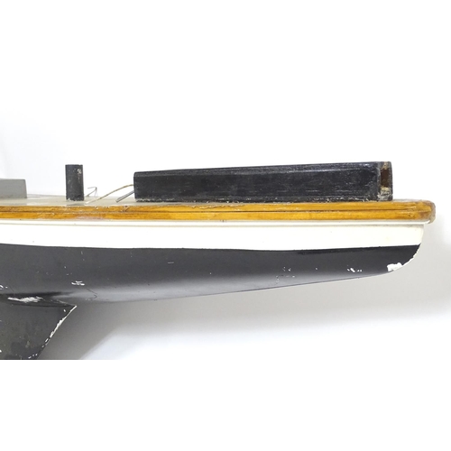 1519 - Toy: A 20thC scratch built wooden model of a boat with polychrome decoration. Approx. 60