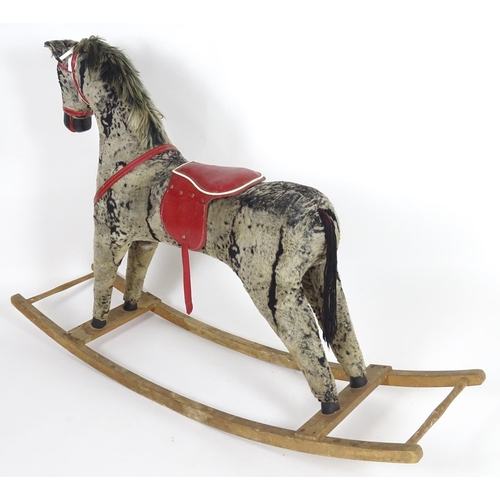 1526 - Toy: A 20thC plush rocking horse on bows with red and white saddle and reins. Approx. 38