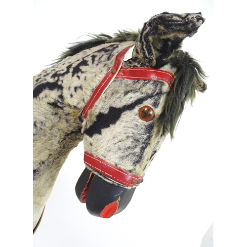 1526 - Toy: A 20thC plush rocking horse on bows with red and white saddle and reins. Approx. 38