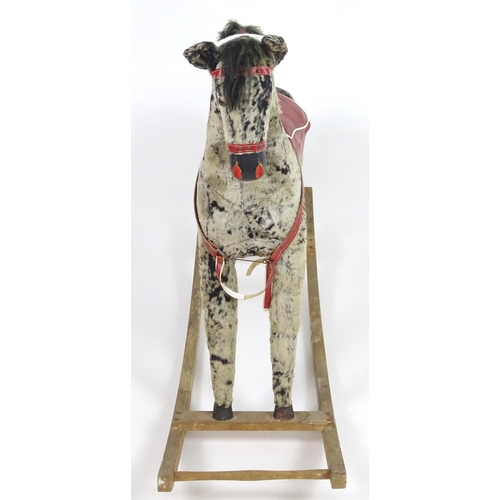 1526 - Toy: A 20thC plush rocking horse on bows with red and white saddle and reins. Approx. 38