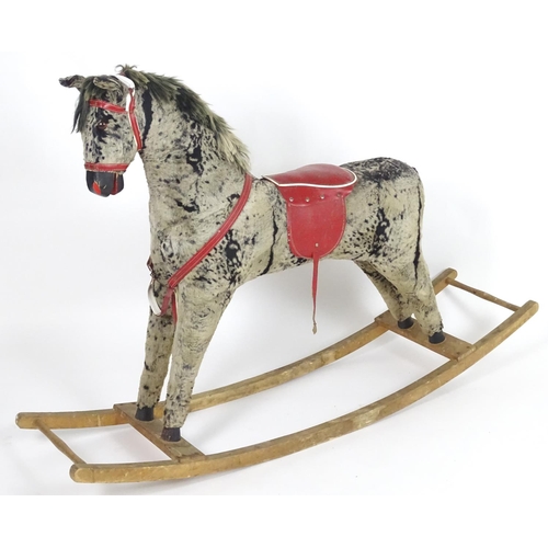 1526 - Toy: A 20thC plush rocking horse on bows with red and white saddle and reins. Approx. 38