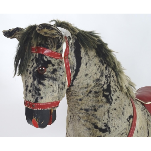 1526 - Toy: A 20thC plush rocking horse on bows with red and white saddle and reins. Approx. 38