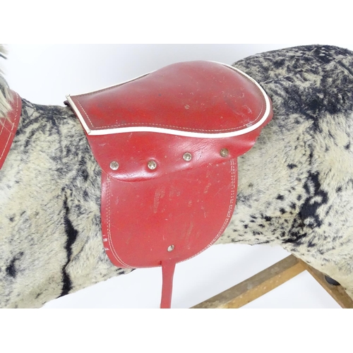 1526 - Toy: A 20thC plush rocking horse on bows with red and white saddle and reins. Approx. 38