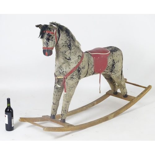 1526 - Toy: A 20thC plush rocking horse on bows with red and white saddle and reins. Approx. 38