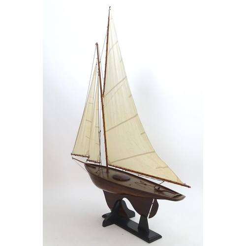 1531 - A 20thC model / pond yacht / boat of large proportions, carvel constructed from mahogany planks with... 