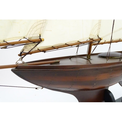 1531 - A 20thC model / pond yacht / boat of large proportions, carvel constructed from mahogany planks with... 