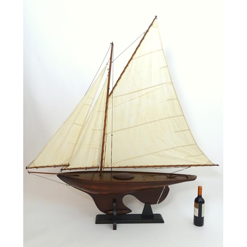 1531 - A 20thC model / pond yacht / boat of large proportions, carvel constructed from mahogany planks with... 