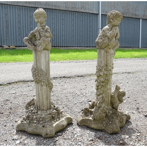 1585 - Garden & Architectural, Salvage: a pair of 20thC reconstituted stone statues formed as cherubs atop ... 