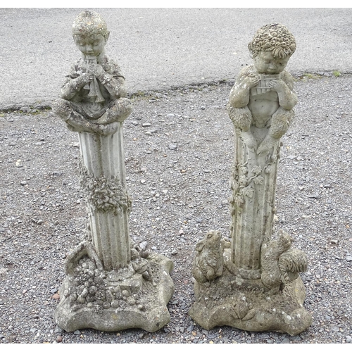 1585 - Garden & Architectural, Salvage: a pair of 20thC reconstituted stone statues formed as cherubs atop ... 