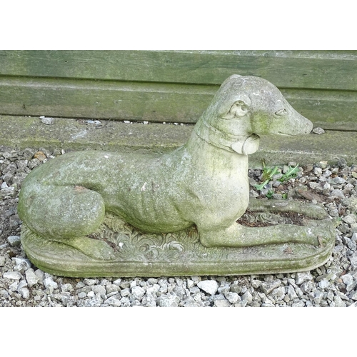 1599 - Garden & Architectural, Salvage: a 20thC reconstituted stone statue of a sejant long dog, approximat... 