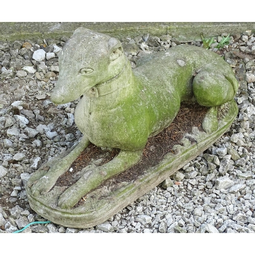 1599 - Garden & Architectural, Salvage: a 20thC reconstituted stone statue of a sejant long dog, approximat... 