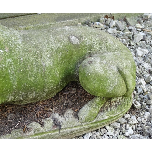 1599 - Garden & Architectural, Salvage: a 20thC reconstituted stone statue of a sejant long dog, approximat... 