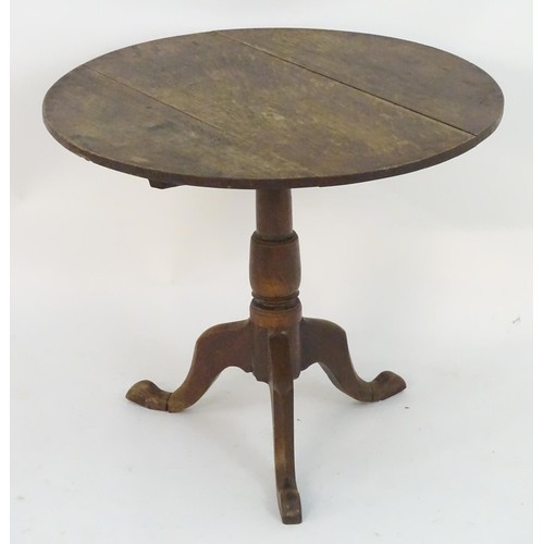 2085 - A late 18thC oak tripod table with a three plank top above a turned pedestal and three cabriole legs... 