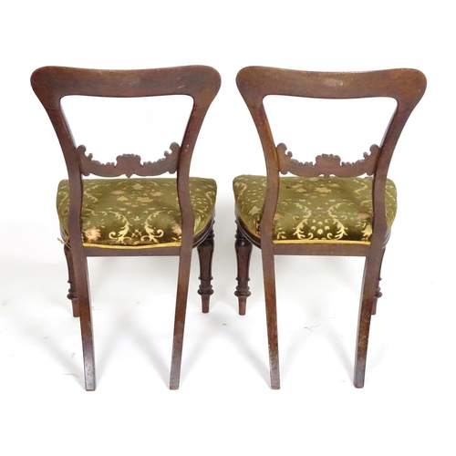 2094 - A pair of 19thC mahogany balloon back side chairs, with carved mid rails above shaped upholstered se... 