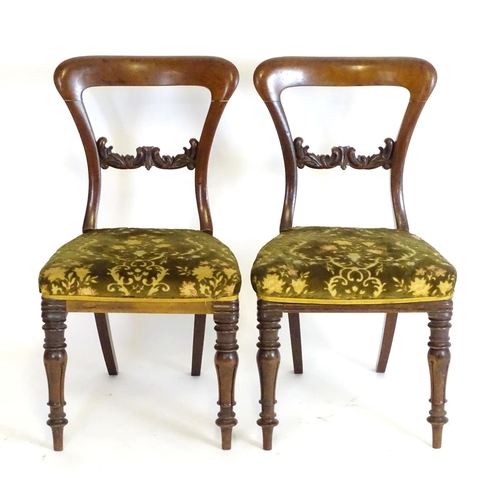 2094 - A pair of 19thC mahogany balloon back side chairs, with carved mid rails above shaped upholstered se... 