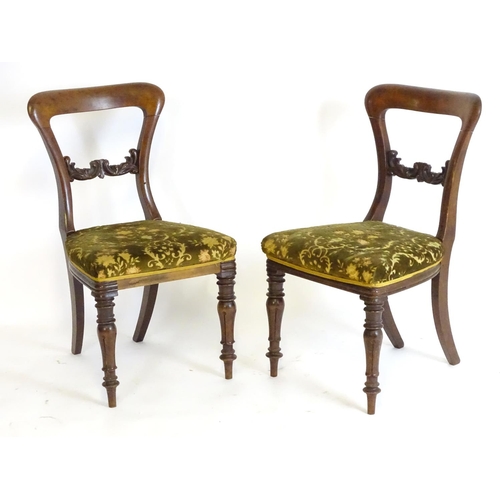 2094 - A pair of 19thC mahogany balloon back side chairs, with carved mid rails above shaped upholstered se... 