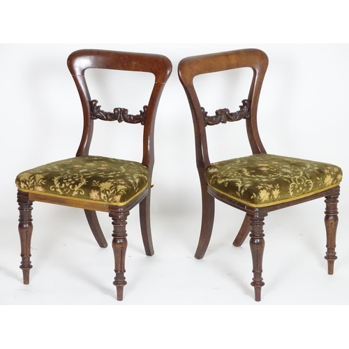 2094 - A pair of 19thC mahogany balloon back side chairs, with carved mid rails above shaped upholstered se... 