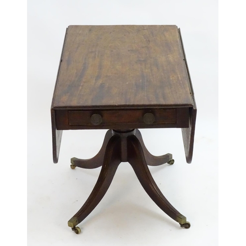 2096 - A mid 19thC mahogany Pembroke table with a rectangular top flanked by drop flaps to each side, havin... 