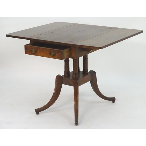 2097 - A Georgian oak Pembroke table with drop flaps, a pedestal base with four turned columns and the tabl... 