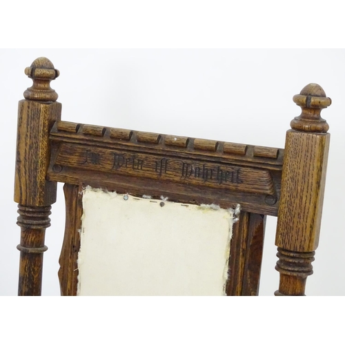 2098 - A pair of 19thC oak Gothic chairs, mounted by carved finials above incised frames with turned suppor... 