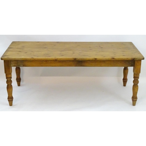 2206 - A mid / late 20thC pine farmhouse table stood on four large turned legs. 78