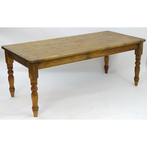 2206 - A mid / late 20thC pine farmhouse table stood on four large turned legs. 78