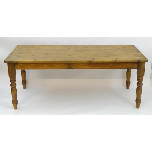 2206 - A mid / late 20thC pine farmhouse table stood on four large turned legs. 78