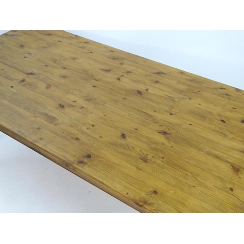 2206 - A mid / late 20thC pine farmhouse table stood on four large turned legs. 78