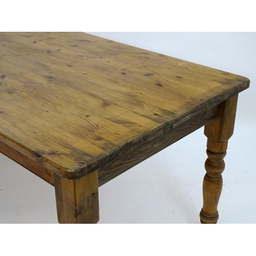 2206 - A mid / late 20thC pine farmhouse table stood on four large turned legs. 78