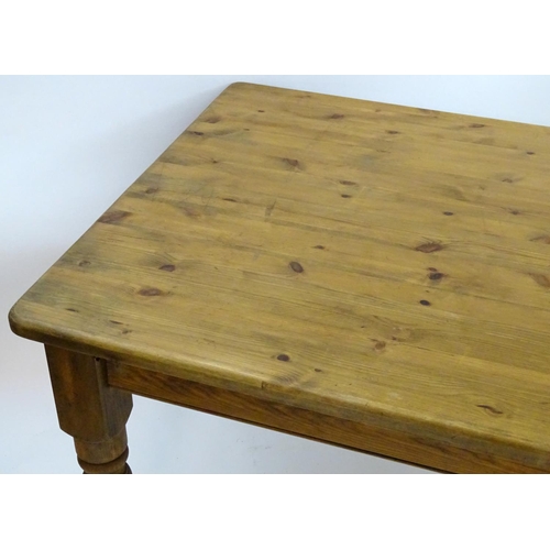 2206 - A mid / late 20thC pine farmhouse table stood on four large turned legs. 78