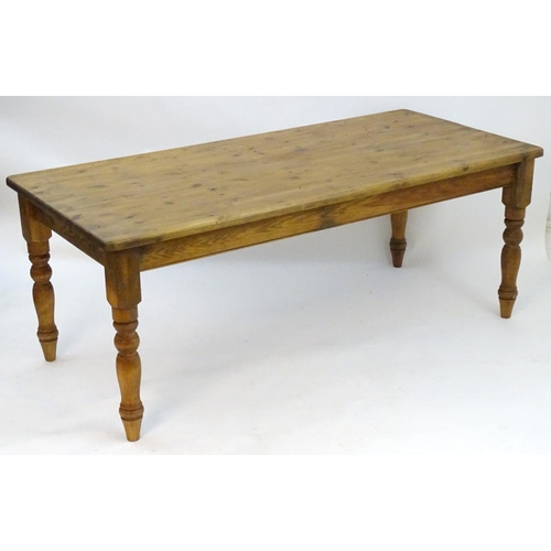 2206 - A mid / late 20thC pine farmhouse table stood on four large turned legs. 78