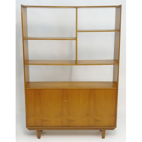 2211 - A Vintage / Retro teak room divider / cabinet with five shelves above two cupboards with shaped hand... 