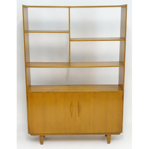 2211 - A Vintage / Retro teak room divider / cabinet with five shelves above two cupboards with shaped hand... 