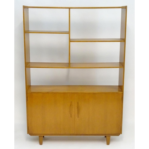 2211 - A Vintage / Retro teak room divider / cabinet with five shelves above two cupboards with shaped hand... 