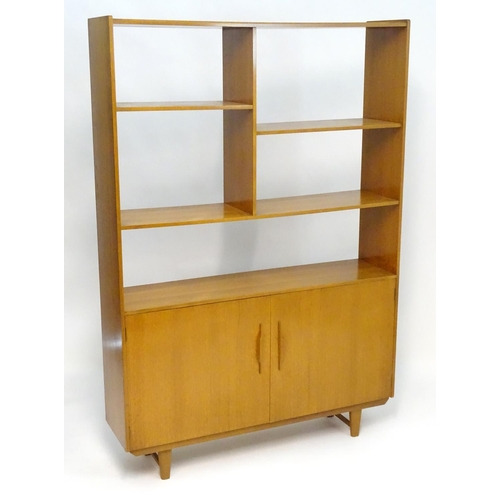 2211 - A Vintage / Retro teak room divider / cabinet with five shelves above two cupboards with shaped hand... 